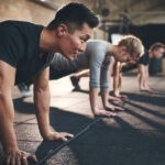 Your Brain Fooled You: Why “Some Movement” Isn’t Enough Group of individuals performing push-ups in a gym
