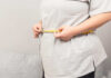 Mayo Clinic Uncovers Hidden Weight Loss Power Combo Person measuring their waist with a tape measure