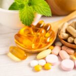 Vitamin Supplements Sabotaging Cancer Treatment? Assorted vitamins and supplements arranged with mint leaves