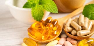 Assorted vitamins and supplements arranged with mint leaves