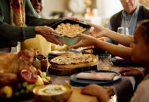 A family sharing a dish during a festive meal