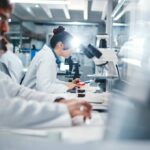 Mitochondria Mystery: The Secret to Immortality? Scientists working in a laboratory with microscopes and test tubes