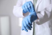 Plaque-Busting Tech for Just $28! A medical professional putting on blue gloves in a clinical setting